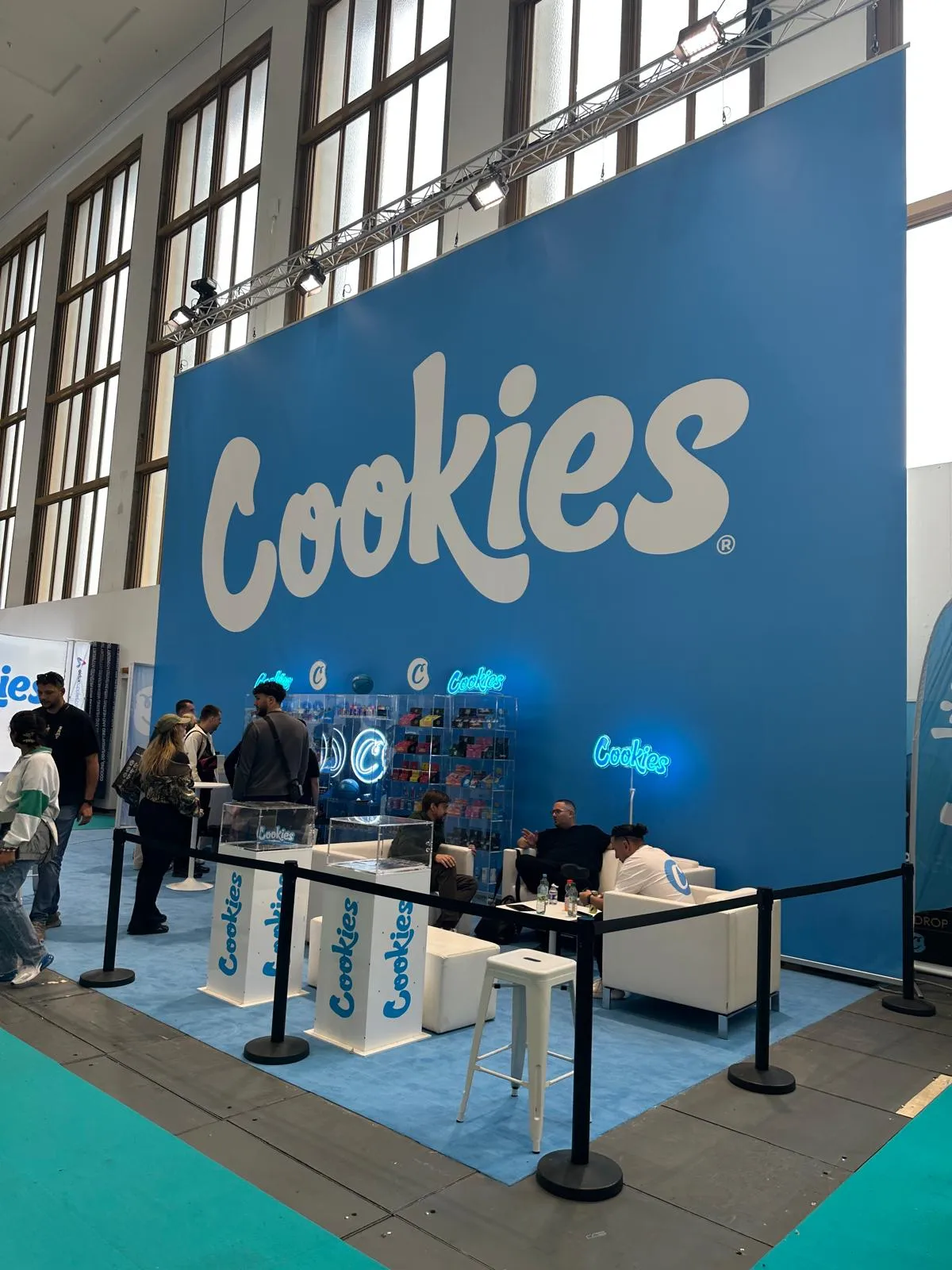 Cookies booth with a large blue branded wall and lounge at Mary Jane Berlin 2026